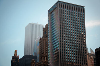 Low angle view of skyscrapers against clear sky