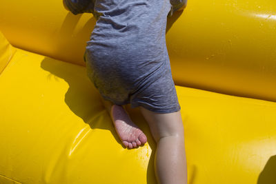 Low section of child climbing bouncy castle at water park