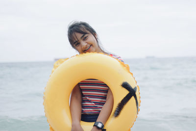 Woman standing on beach against sky