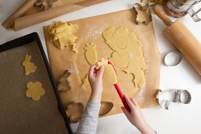 Cropped hand of person preparing food on table