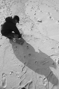 High angle view of woman walking on sand