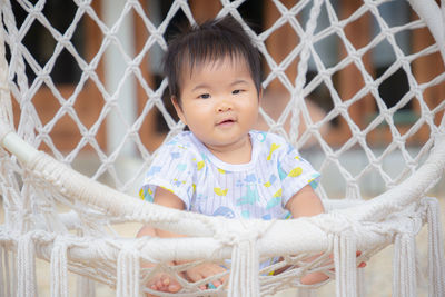 Portrait of cute girl in fence