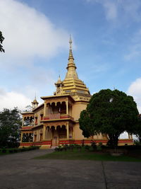 View of temple building against cloudy sky