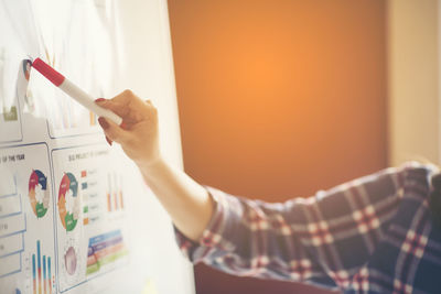 Midsection of businessman working over graph at office