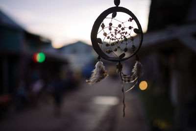 Close-up of dreamcatcher hanging during sunset