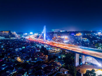 High angle view of illuminated city street and buildings at night