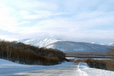 Scenic view of snow covered mountains against sky