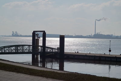 View of pier on sea against cloudy sky