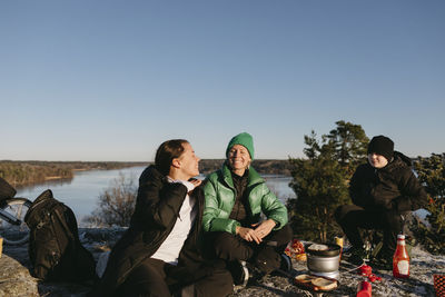 Smiling women camping at winter