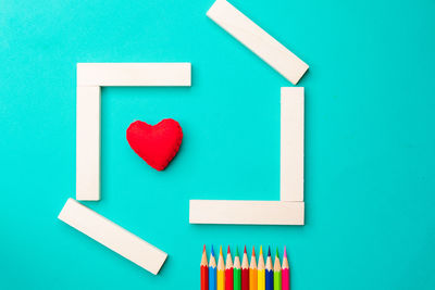 Close-up of heart shape on blue table