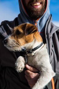 Midsection of man with dog