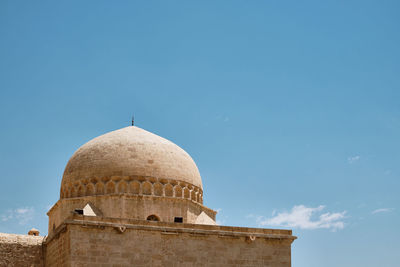 Low angle view of building against blue sky