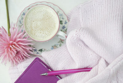 Workplace for a young girl, a cup of cappuccino, spring pink lifestyle concept, morning mood
