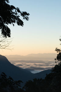 Golden sunrise light hits the fog in the mountains of the  serra dos Órgãos national park in 