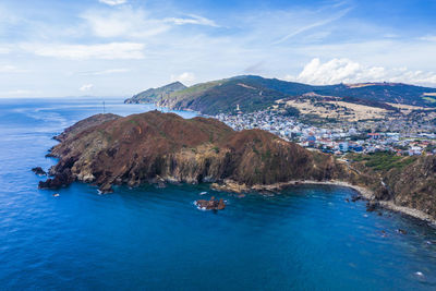 Scenic view of sea and mountains against sky