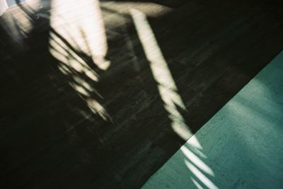 High angle view of shadow on wooden floor