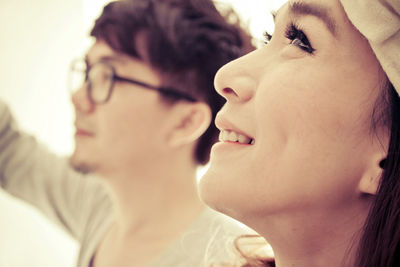 Close-up of young couple looking away