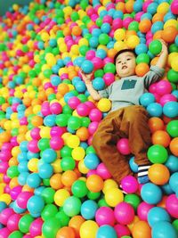 Portrait of boy with multi colored balloons