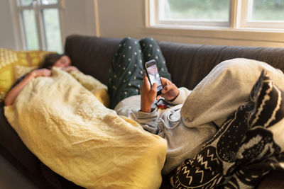 Woman on sofa using cell phone