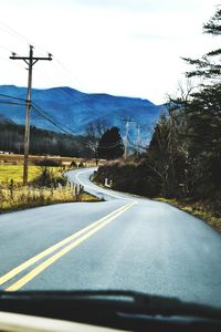 Road by landscape seen through car windshield