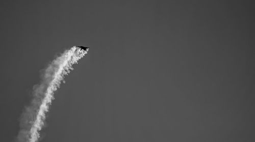 Low angle view of airplane flying against sky