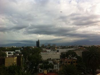 Buildings against cloudy sky