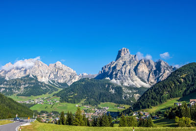 Scenic view of mountains against blue sky