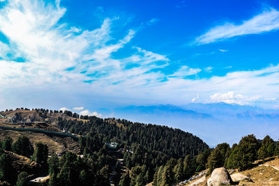 Scenic view of mountains against blue sky