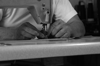 Midsection of man working at workshop