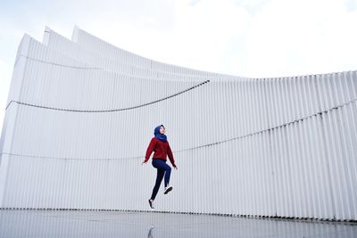 Full length of man with umbrella against sky