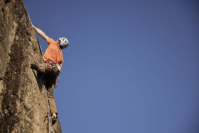 Rock climber reaching top