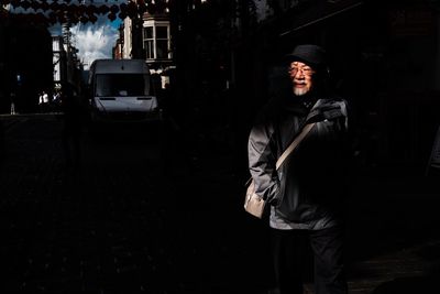 Woman standing in the dark