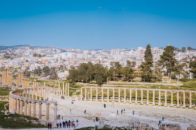 The oval forum of the jerash archaeological site with the new part of the city in the background