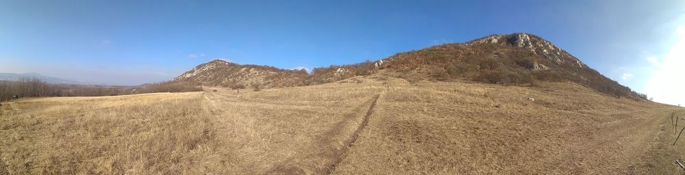 Scenic view of mountains against clear blue sky