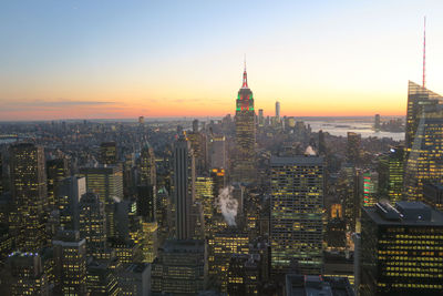 Aerial view of city lit up at sunset