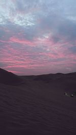 Scenic view of desert against sky during sunset