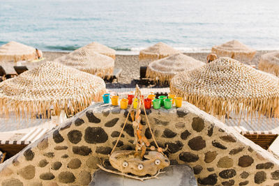 High angle view of roofs at beach against sea