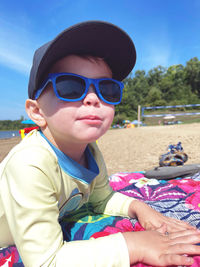 Portrait of young woman sitting at beach