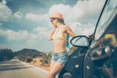 Full length of woman on road against sky