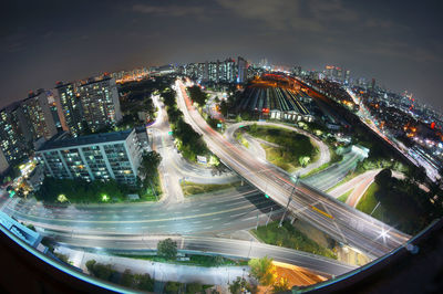 High angle view of light trails on highways in city at night