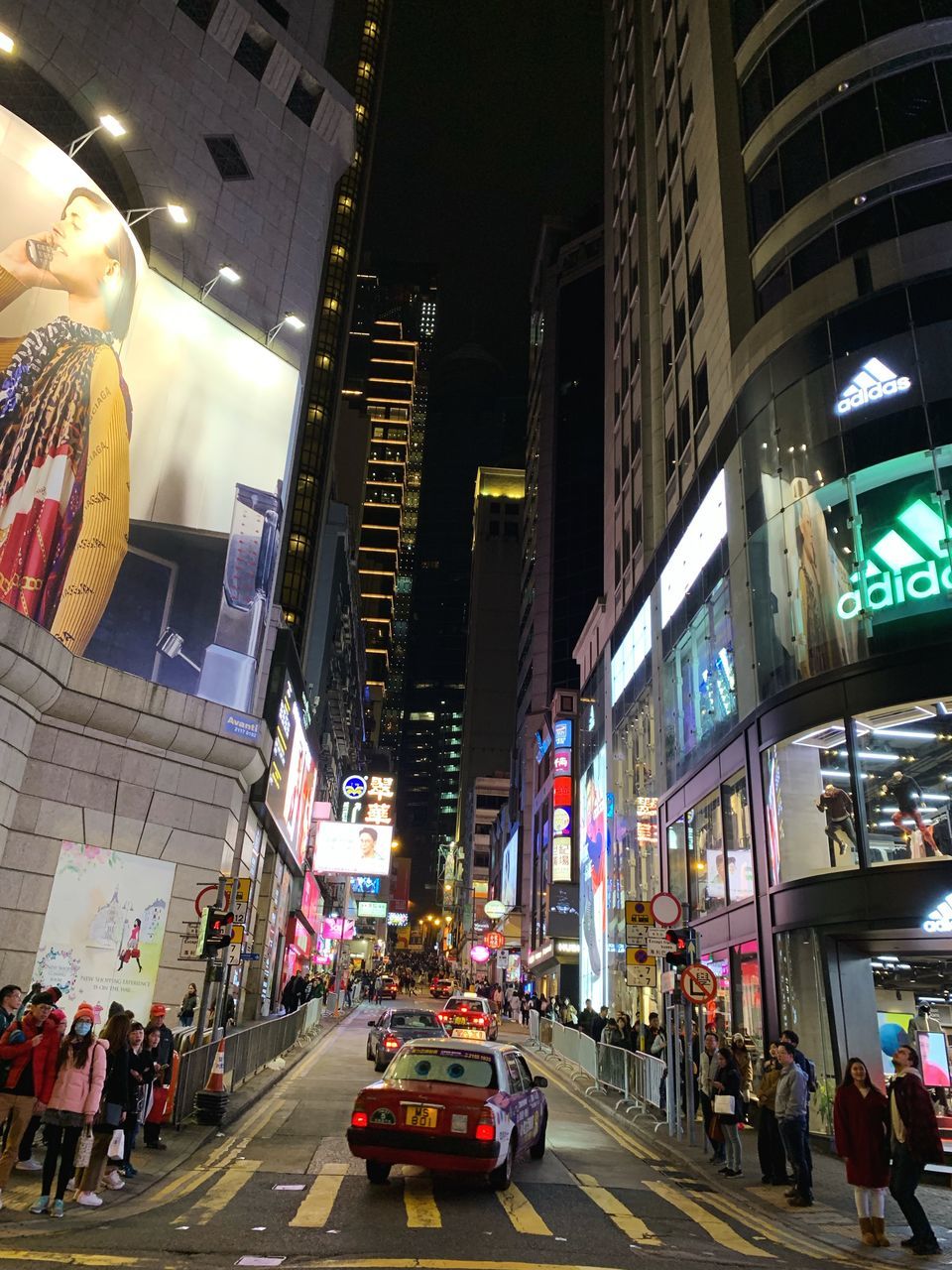 CARS ON CITY STREET AND BUILDINGS AT NIGHT