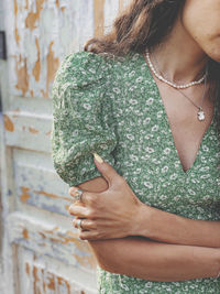 Midsection of woman standing against blurred background