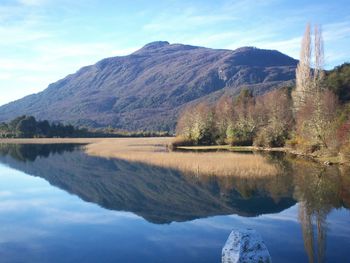 Scenic view of lake and mountains against sky