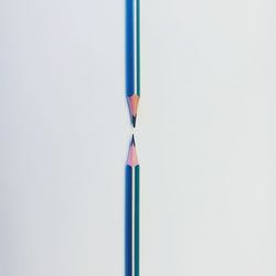 Close-up of colored pencils over white background