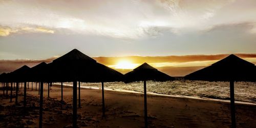 Scenic view of beach against sky during sunset