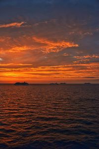 Scenic view of sea against romantic sky at sunset