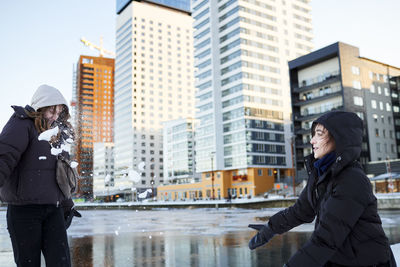 Young women having snowball fight