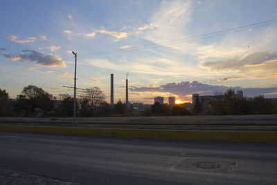 Street against sky during sunset