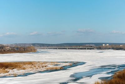 Distant view to the bridge over the frozen river