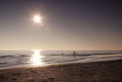 Scenic view of beach against sky during sunset